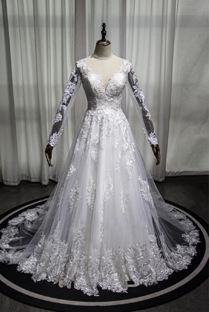 Long sleeved embroidered lace V-neck cathedral train wedding dress