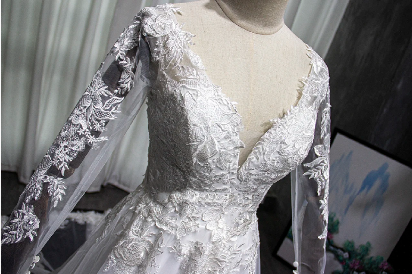 Long sleeved embroidered lace V-neck cathedral train wedding dress